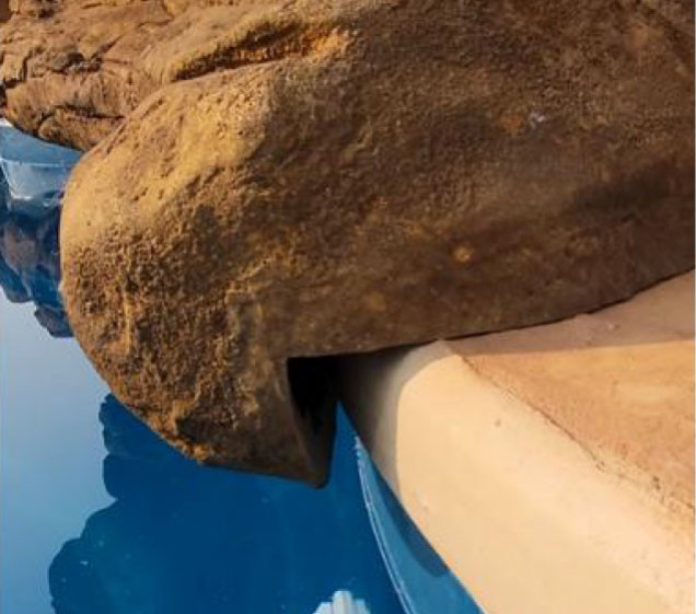 faux rock waterfall overhang on swimming pool