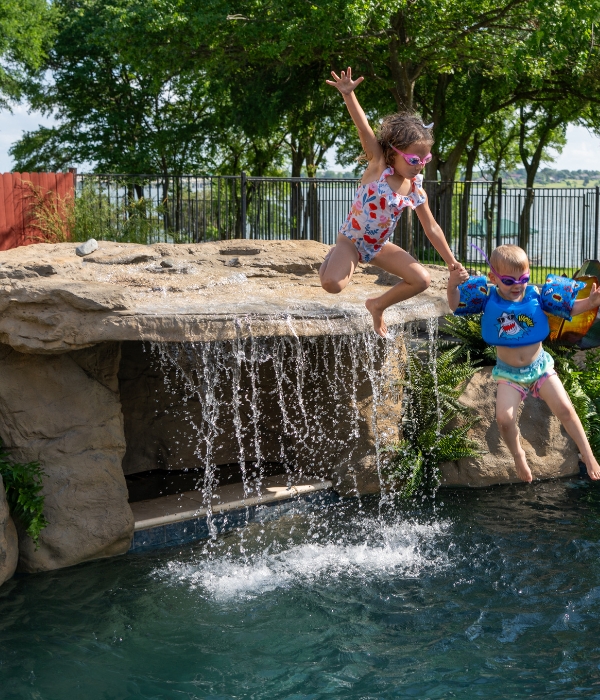 backyard pool party with waterfall