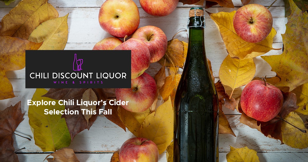 green bottle among red apples and fall leaves