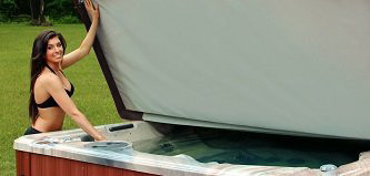 woman smiling opening hot tub cover