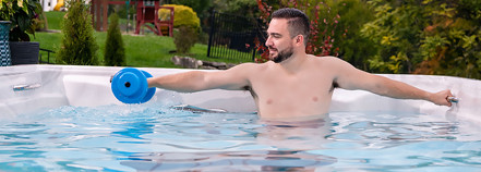 man lifting weights in fitness spa