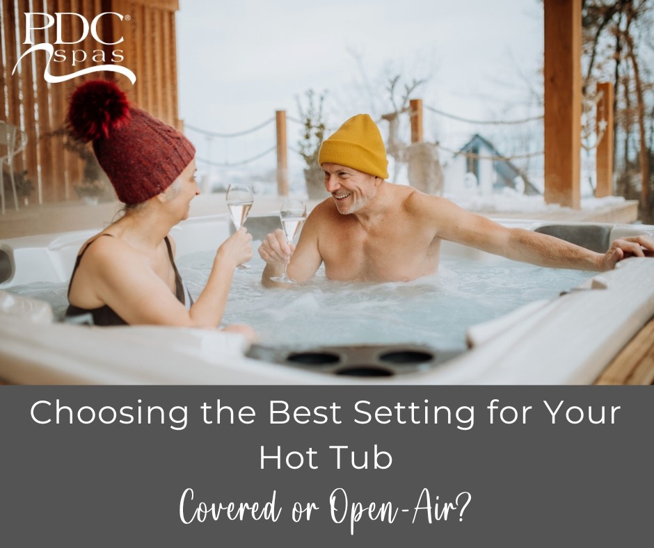 a man and a woman in snow hats smiling enjoying a warm hot tub outdoors in the winter