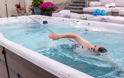 man swimming in swim spa using swim tether