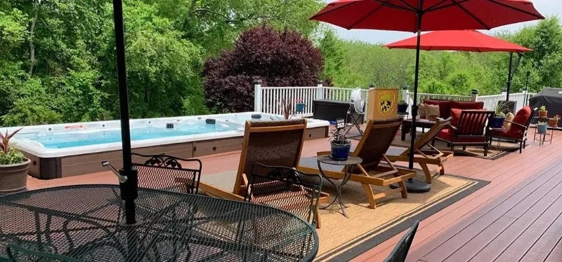 pdc spas splash series pool alternative on deck with patio furniture and outdoor umbrella