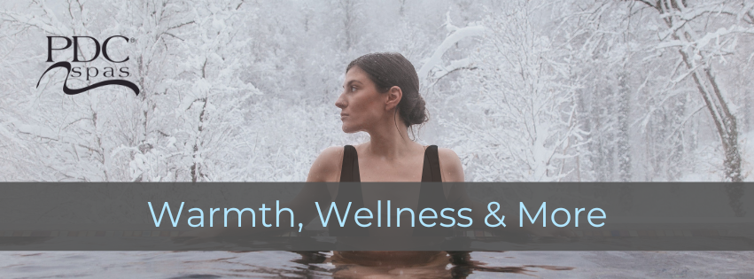 woman soaking in a pdc spas hot tub in the winter time