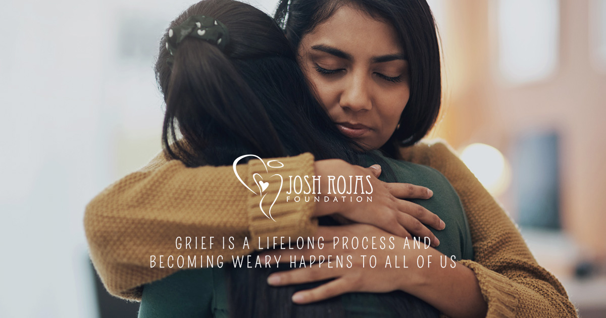 two individuals embracing with comforting expressions, logo and quote visible