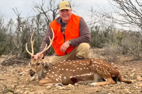 hunter with trophy axis buck