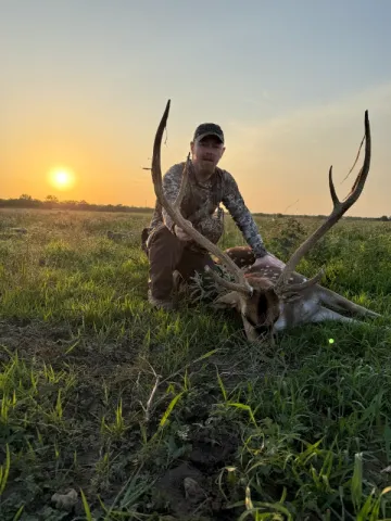 hunter with trophy axis buck