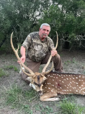hunter wtih axis buck trophy