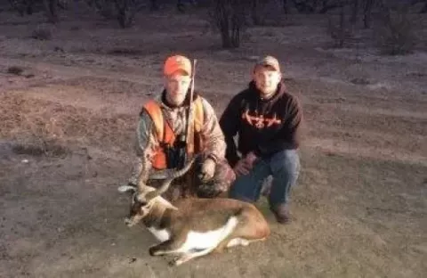 two male hunters with trophy buck