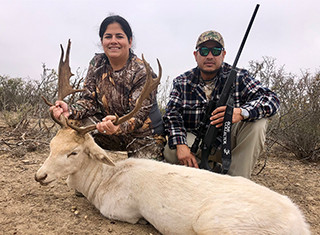 man and woman with trophy deer