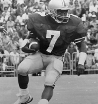football player in action wearing number 7 jersey holding a football black and white photo