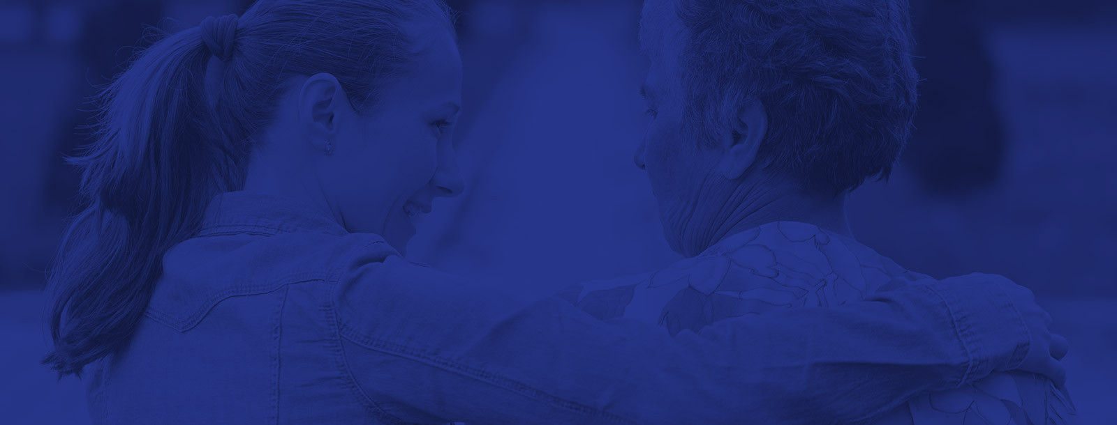 two people embracing one with a ponytail in a close supportive gesture blue overlay