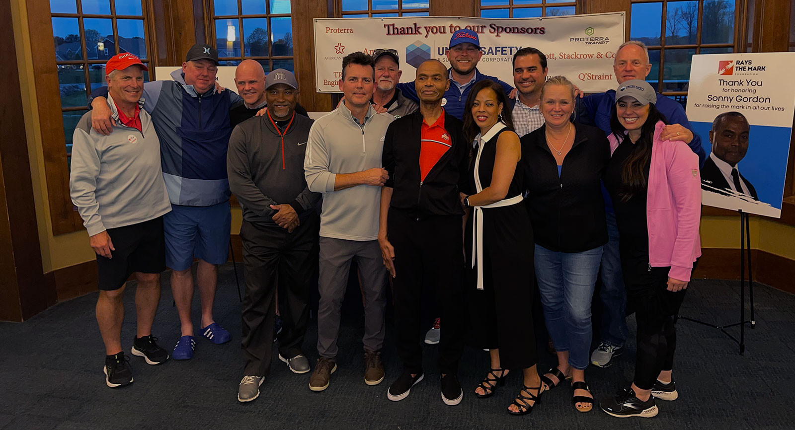 group of people posing indoors in casual attire