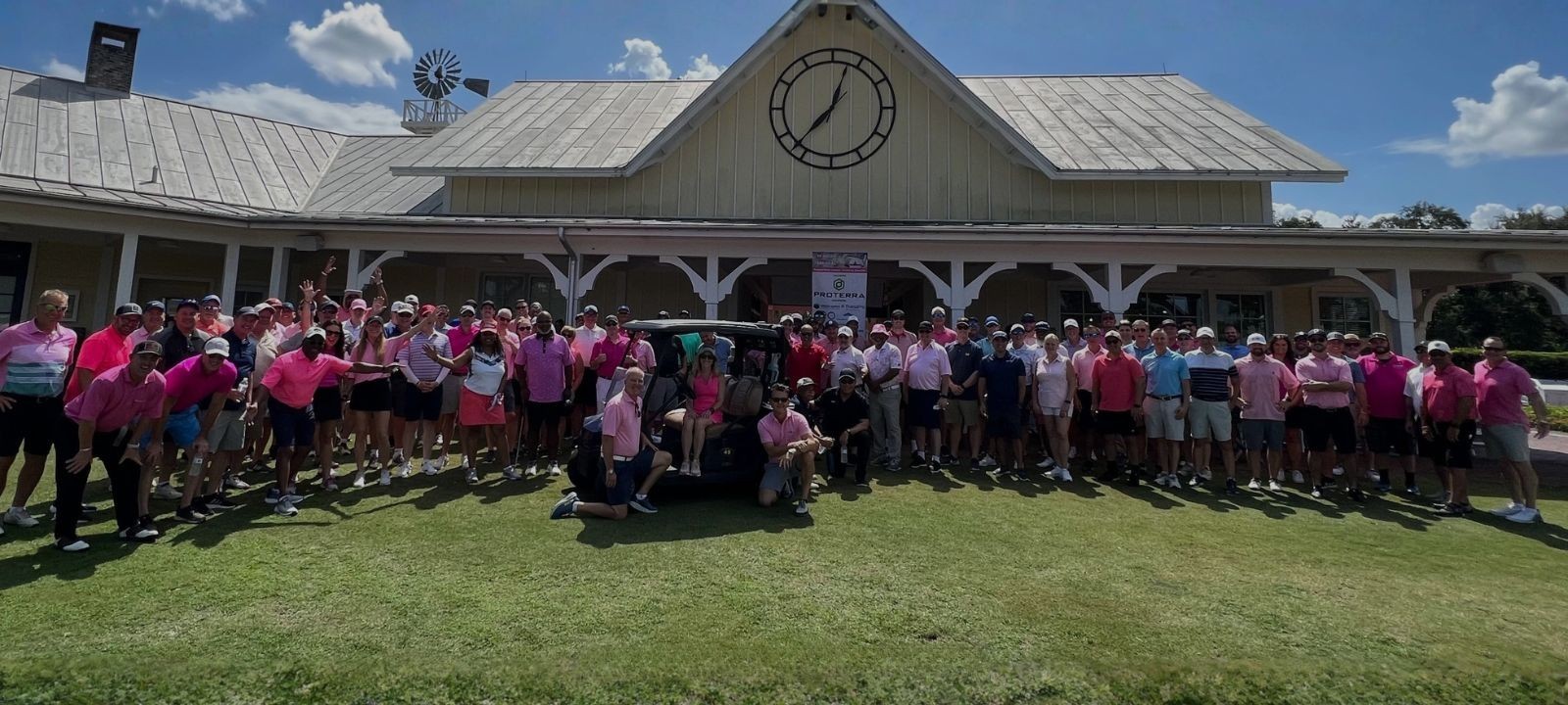 two men talking outdoors with trees and a building in the background blue gradient overlay