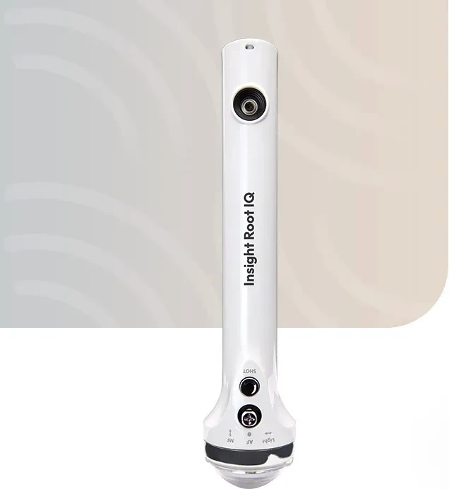 White handheld dental device labeled Insight Root IQ with lens and control buttons on front.