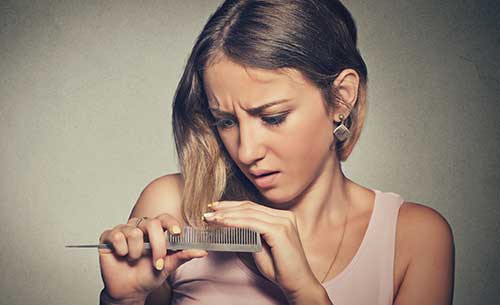 Woman experiencing hair loss