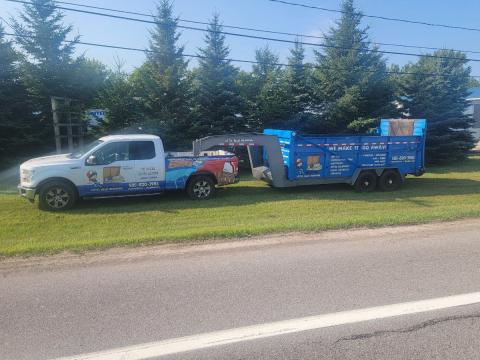 full shot of little blue removal truck with blue junk trailer