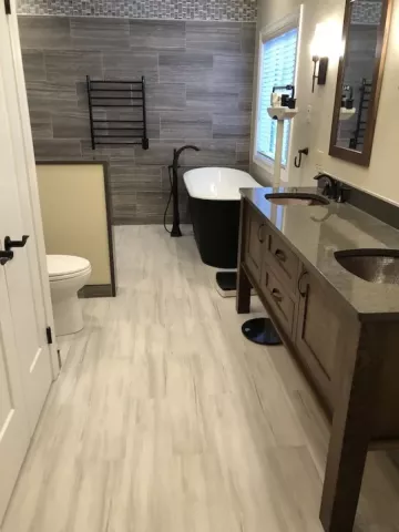 beautiful new bath with tile walls and laminate flooring