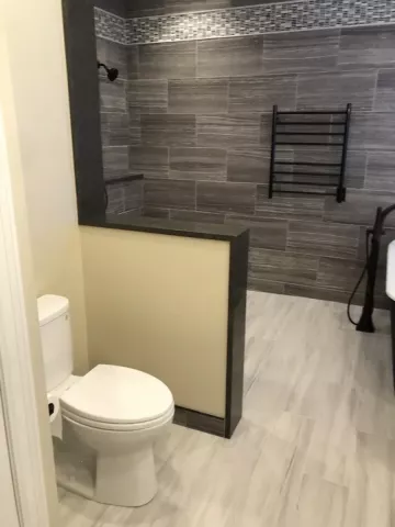 new bathroom toilet and half wall installed by class a construction