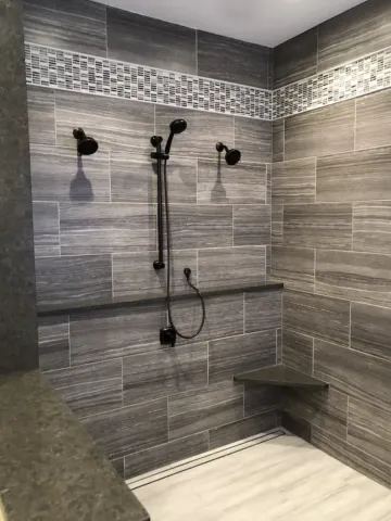 new very large walk in shower with grey tile walls