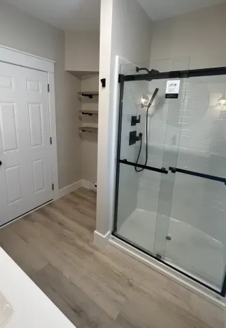 a modern bathroom with black fixtures and beige walls