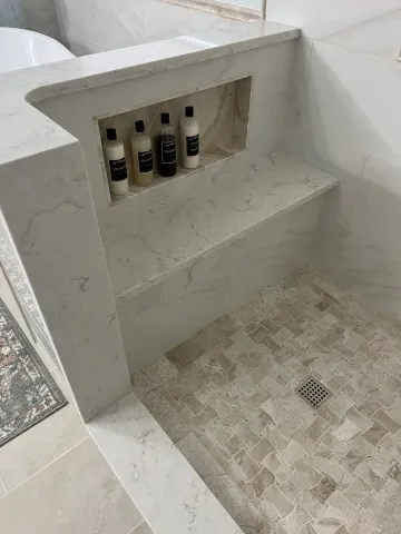 New grey and beige tile in a shower stall