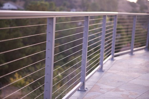 stainless cable railing solution with wooded background