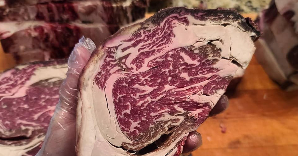 Butcher holding cut of steak