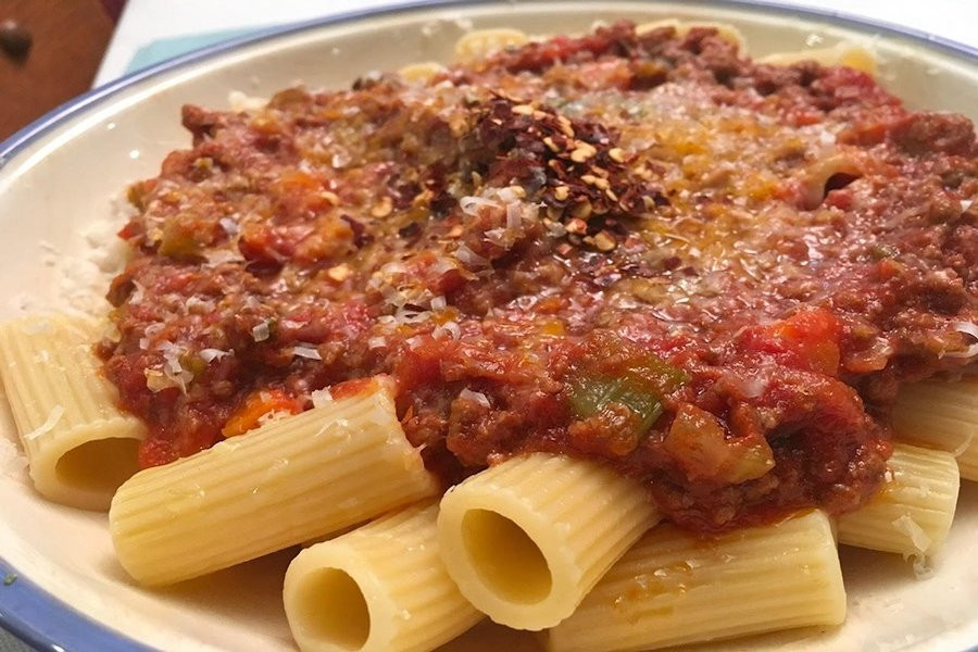 bolognese sauce over rigatoni pasta