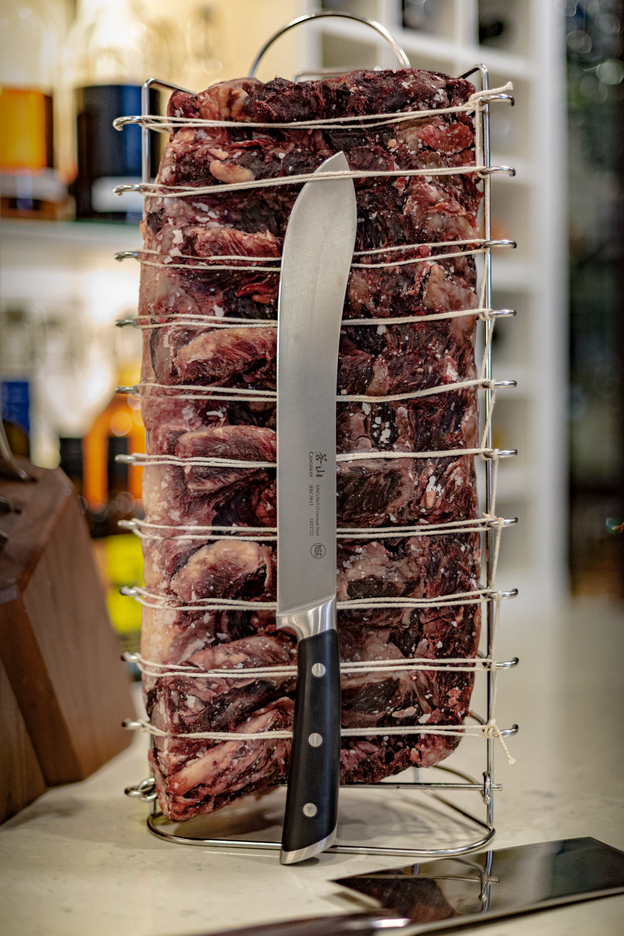 a knife resting up against a steak before it goes in the SteakAger