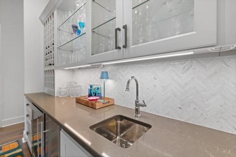white chevron backsplash with brown counter