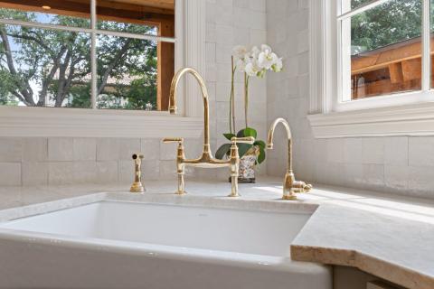 white square tile backsplash gold accented sink