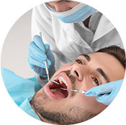 man getting teeth cleaned by dentist
