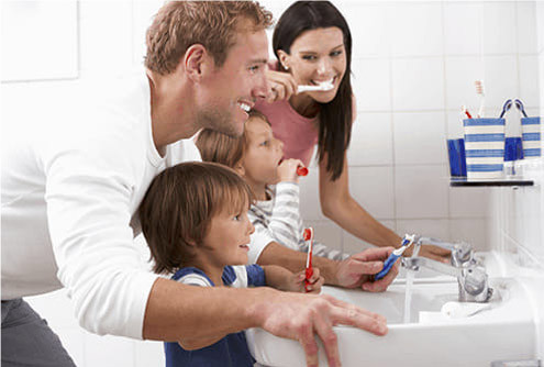 family brushing teeth
