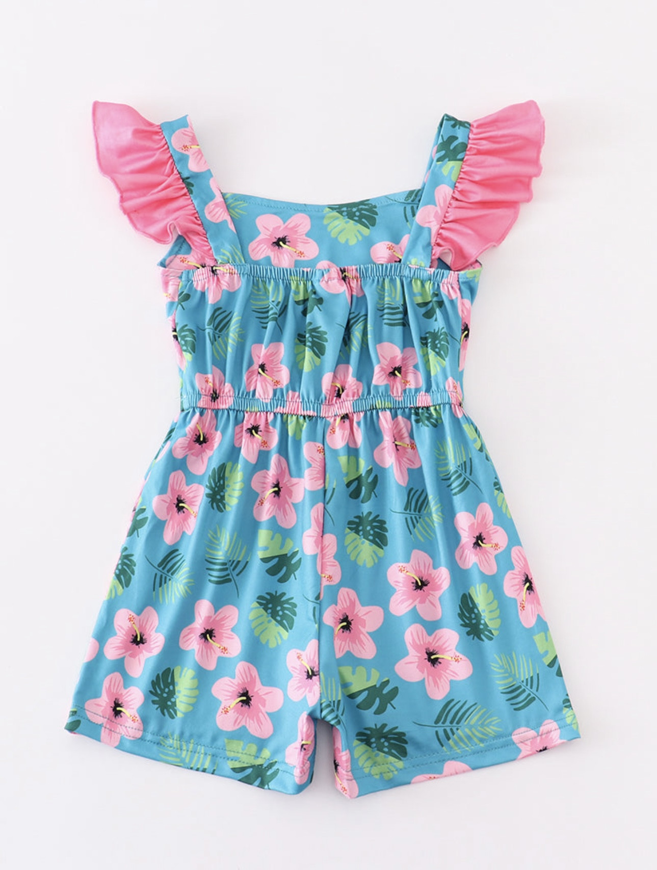 Turquoise romper with hot pink hibiscus flowers and palm leave