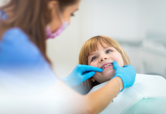 young childe being examined for gum disease