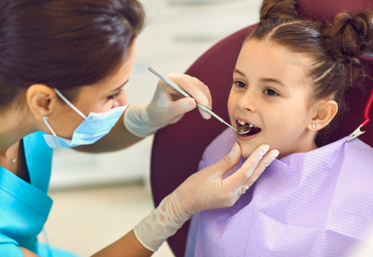 young girl on her first dental visit