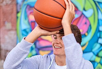 boy holding up a basketball