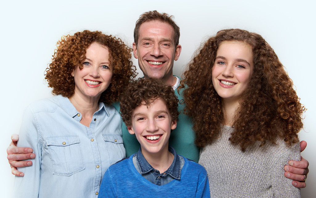 A family of four smiling