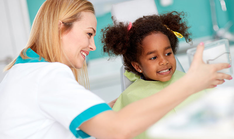 pediatric dentist helping child